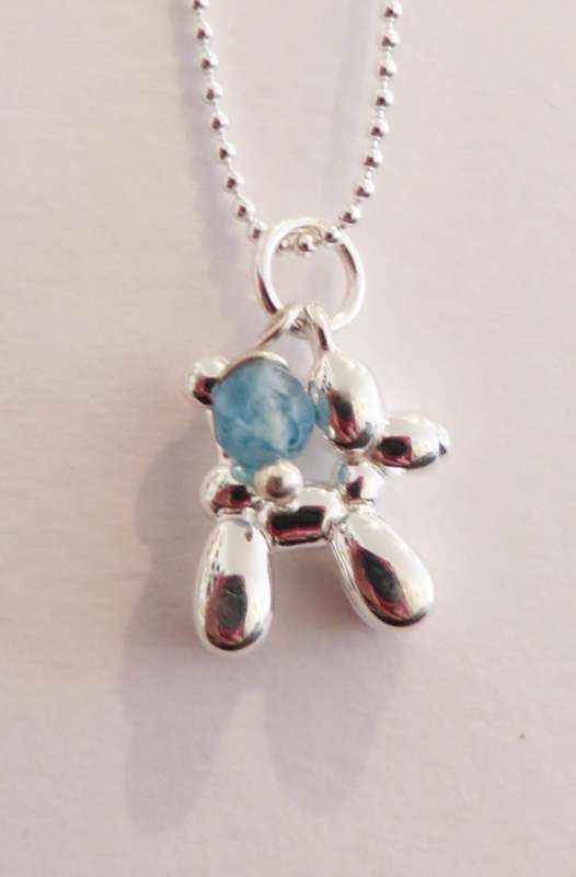 Silver pendant with balloon dog charm and blue stone
